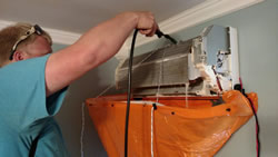 SMS technician servicing ductless mini-split system